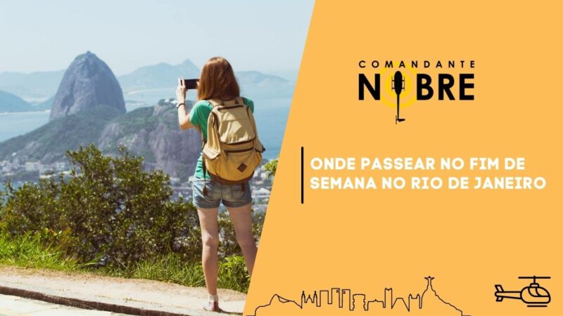 Mulher jovem fotografando a pedra da gávea no Rio de Janeiro.